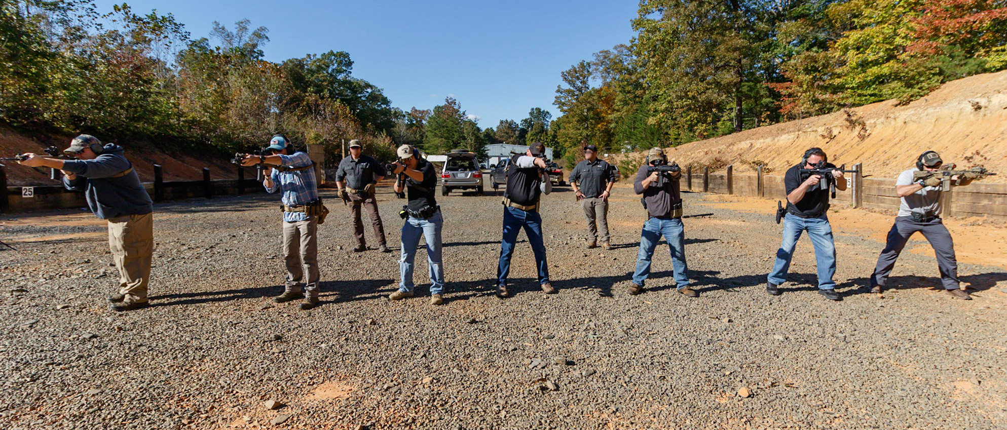 men firing at the gun range